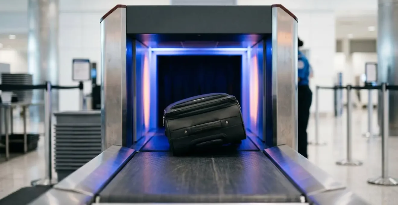 Dettaglio ravvicinato di uno scanner a raggi X aeroportuale che mostra bagagli in controllo